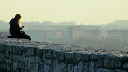 Una joven mira un horizonte repleto de viviendas y edificios.